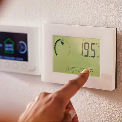Hand adjusting a digital home thermostat set to 19.5 degrees